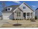 Charming home with stone accents, a well-manicured lawn, and a welcoming front porch at 14230 Morningate St, Huntersville, NC 28078