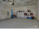 Spacious garage with epoxy floor, ample storage, and overhead door at 14230 Morningate St, Huntersville, NC 28078