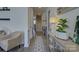 Bright hallway with hardwood floors, elegant trim, and stylish decor leading to the staircase at 14230 Morningate St, Huntersville, NC 28078