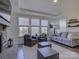 Bright living room featuring a stone fireplace, mantle-mounted TV, and hardwood floors at 14230 Morningate St, Huntersville, NC 28078
