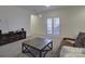 Spacious living room with French doors and a cozy sofa at 14230 Morningate St, Huntersville, NC 28078