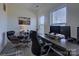 Bright home office featuring large windows, a modern desk setup, and comfortable seating at 14230 Morningate St, Huntersville, NC 28078