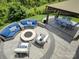 Spacious outdoor patio with comfortable seating, a fire pit, and an elegant dining space at 14230 Morningate St, Huntersville, NC 28078