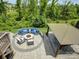 Stunning outdoor patio with a fire pit, cozy seating, and a gazebo-covered dining area at 14230 Morningate St, Huntersville, NC 28078