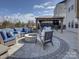 Beautiful backyard patio with an outdoor seating area around a fire pit and a covered dining area with a large table at 14230 Morningate St, Huntersville, NC 28078