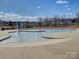 Community pool with a splash pad feature, surrounded by a secure fence, perfect for Gathering fun and relaxation at 14230 Morningate St, Huntersville, NC 28078