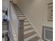 Elegant staircase with wooden treads, white risers and railings, blending modern design with classic charm at 14230 Morningate St, Huntersville, NC 28078