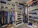Spacious walk-in closet with custom shelving, hanging rods, and ample storage for clothes and accessories at 14230 Morningate St, Huntersville, NC 28078