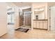 Main bathroom featuring large walk-in shower, tile floors, white cabinets, and granite countertops at 15317 Colonial Park Dr, Huntersville, NC 28078