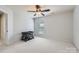 Spare bedroom with neutral walls, carpet, and a compact crib perfect for Bedroom or guest space at 15317 Colonial Park Dr, Huntersville, NC 28078