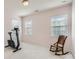 Bonus room or spare bedroom with wood rocking chair, workout bike, neutral walls, and ample natural light at 15317 Colonial Park Dr, Huntersville, NC 28078