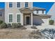 Welcoming front porch and two-car garage surrounded by manicured landscaping at 15317 Colonial Park Dr, Huntersville, NC 28078