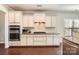 Modern kitchen featuring stainless steel appliances, granite counters, and tiled backsplash at 15317 Colonial Park Dr, Huntersville, NC 28078