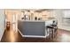 Bright kitchen with granite counters, stainless appliances, gray kitchen island with barstool seating, and hardwood flooring at 15317 Colonial Park Dr, Huntersville, NC 28078