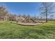 Community playground featuring a slide and climbing structure with a swimming pool in the background at 15317 Colonial Park Dr, Huntersville, NC 28078