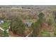 Aerial view of home surrounded by mature trees, with an in-ground pool and fenced in yard at 1770 Cranwell Dr, Mt Ulla, NC 28125