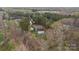 Aerial view of a brick home with an in-ground pool surrounded by mature trees at 1770 Cranwell Dr, Mt Ulla, NC 28125