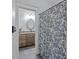 Hall bathroom with a patterned shower curtain and dark wood vanity with granite countertop at 1770 Cranwell Dr, Mt Ulla, NC 28125