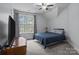 Bedroom featuring carpet, a window with curtains, and a dresser with a TV at 1770 Cranwell Dr, Mt Ulla, NC 28125