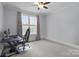 Comfortable bedroom with neutral tones, carpet, and natural light from a large window at 1770 Cranwell Dr, Mt Ulla, NC 28125
