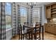 Cozy breakfast nook features a wood table and chairs, with large windows and natural light at 1770 Cranwell Dr, Mt Ulla, NC 28125