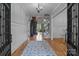 Elegant foyer with hardwood floors, wainscoting, and a view into the living area with a stone fireplace at 1770 Cranwell Dr, Mt Ulla, NC 28125