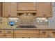 Modern stovetop with stone backsplash and wooden cabinets, perfect for cooking at 1770 Cranwell Dr, Mt Ulla, NC 28125