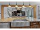 Open-concept kitchen with stone countertops and modern stainless steel sink at 1770 Cranwell Dr, Mt Ulla, NC 28125