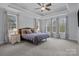 Spacious main bedroom with tray ceiling, plush carpet, and multiple bright windows at 1770 Cranwell Dr, Mt Ulla, NC 28125