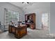 Spacious office with large windows, a dark wood desk, and ample storage space at 1770 Cranwell Dr, Mt Ulla, NC 28125