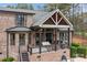 Brick home exterior with a covered deck, outdoor seating, and a beautiful backyard at 1770 Cranwell Dr, Mt Ulla, NC 28125