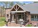 Brick home with a covered deck, outdoor seating, grill and well manicured backyard at 1770 Cranwell Dr, Mt Ulla, NC 28125