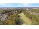 Aerial view of the golf course, showcasing the community, lake, and surrounding tree landscape at 17733 Colleton River Ln, Charlotte, NC 28278