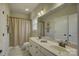 Well-lit bathroom with a double sink vanity, updated fixtures, a large mirror, and a shower with curtain at 17733 Colleton River Ln, Charlotte, NC 28278