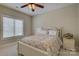 Bright bedroom features a floral patterned comforter, ceiling fan, and window at 17733 Colleton River Ln, Charlotte, NC 28278