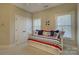 Bright, nautical-themed bedroom with built-in storage daybed, white trim, and coordinated decor at 17733 Colleton River Ln, Charlotte, NC 28278