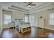 Bright bedroom featuring a tray ceiling, hardwood floors, paneled accent wall, and coordinating furniture at 17733 Colleton River Ln, Charlotte, NC 28278