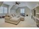 Open concept bonus room features natural light, vaulted ceilings, and neutral paint at 17733 Colleton River Ln, Charlotte, NC 28278