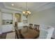 Bright dining room featuring elegant built-in cabinets and a classic chandelier at 17733 Colleton River Ln, Charlotte, NC 28278