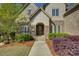 Stone and brick home showcases a covered front entrance with beautiful wooden door at 17733 Colleton River Ln, Charlotte, NC 28278