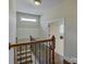 Hallway featuring hardwood steps, iron spindles, and a beautiful landing at 17733 Colleton River Ln, Charlotte, NC 28278