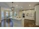 Modern kitchen features a large island with granite countertops, stainless steel appliances, and ample storage at 17733 Colleton River Ln, Charlotte, NC 28278
