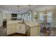 Open concept kitchen with granite counters, stainless appliances, and view to living and dining areas at 17733 Colleton River Ln, Charlotte, NC 28278