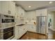 Well lit kitchen featuring stainless steel appliances, granite counters, and all white cabinetry at 17733 Colleton River Ln, Charlotte, NC 28278
