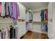 Organized walk-in closet with custom shelving, drawers, and rods to maximize storage space and accessibility at 17733 Colleton River Ln, Charlotte, NC 28278