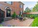 Charming brick home featuring a fenced brick patio with an outdoor dining area at 1801 Maryland Ave, Charlotte, NC 28209