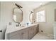 Bathroom featuring double sinks, patterned floors, modern fixtures, and natural light from the windows at 1801 Maryland Ave, Charlotte, NC 28209
