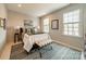 Comfortable bedroom features neutral decor, natural light and accent lamps at 1801 Maryland Ave, Charlotte, NC 28209