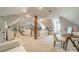 Open-concept bonus room with varied seating, modern decor, and vaulted ceilings at 1801 Maryland Ave, Charlotte, NC 28209