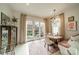 Sunny dining nook with banquette seating, chandelier, and view of landscaped backyard at 1801 Maryland Ave, Charlotte, NC 28209